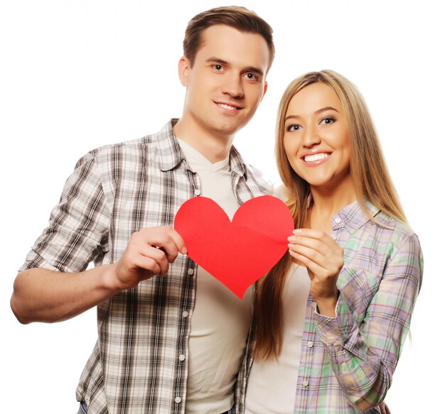 Happy couple in love holding red heart