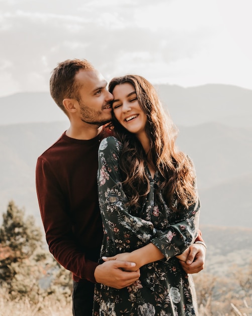 Happy couple in love in the mountains