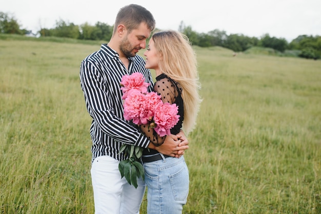 Happy couple in love at sunset and smiling