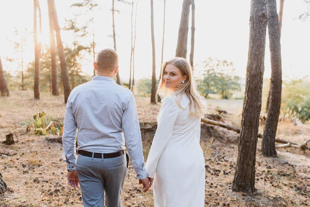 Happy couple in love at sunset and smiling