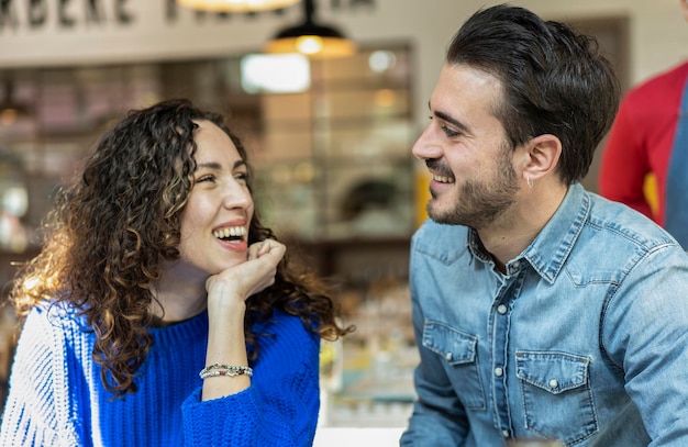 Happy couple of lover Funny situation with both man and woman looking into each eyes Relationship concept with boyfriend and girlfriend at first date