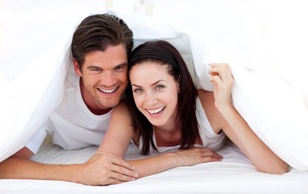 Happy Couple lying on bed