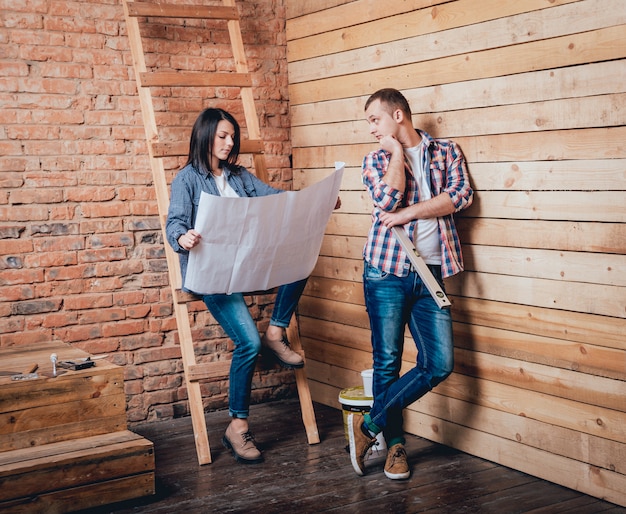 Photo happy couple making repairs to their home.