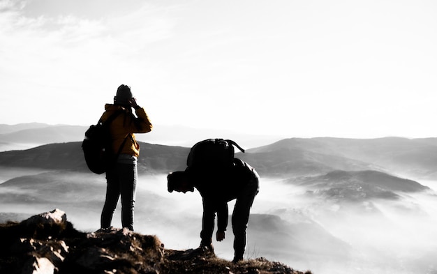 Foto felice coppia uomo e donna turista in cima alla montagna durante un'escursione in estate