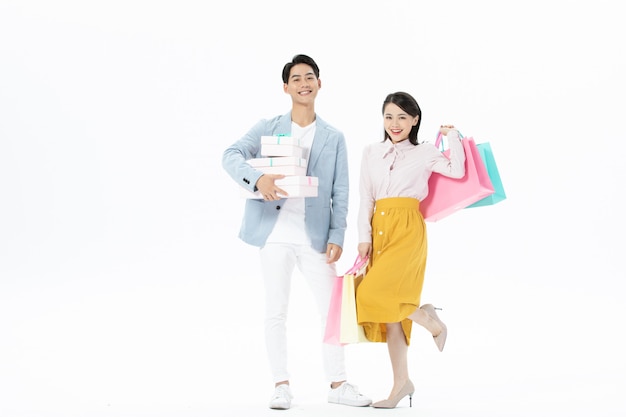 Happy couple man and woman with shopping bags isolated