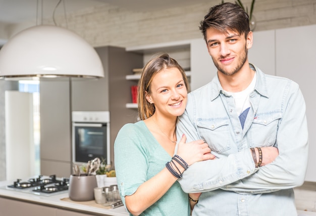 Happy couple portrait in the kitchen