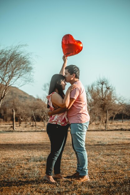 Happy couple posing in the field just married wedding couple