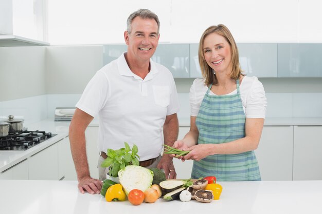 Happy couple preparing food together in kitchen