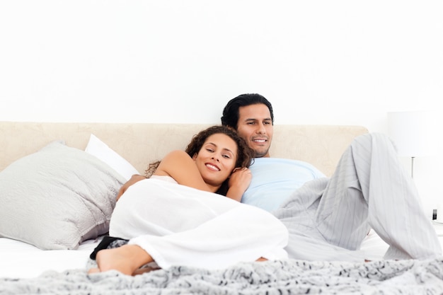 Happy couple relaxing together on their bed