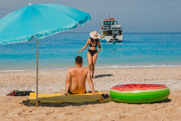 Happy couple resting at Greece happy beach copy space