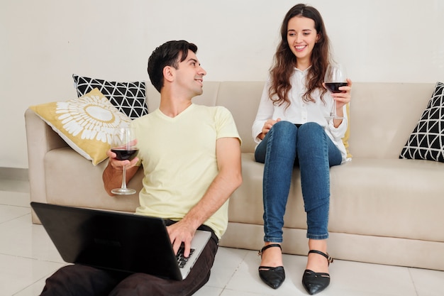 Happy couple resting with gadgets