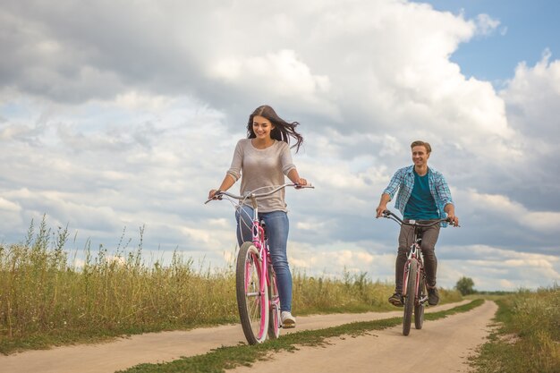 The happy couple riding a bike outdoor