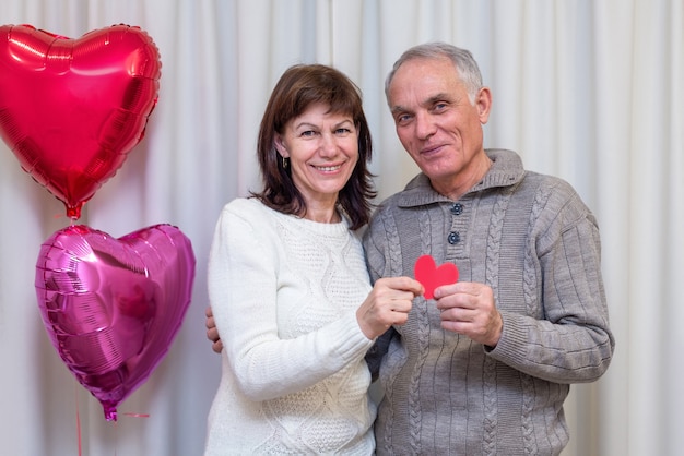 Photo happy couple seniors celebrate valentine's day.