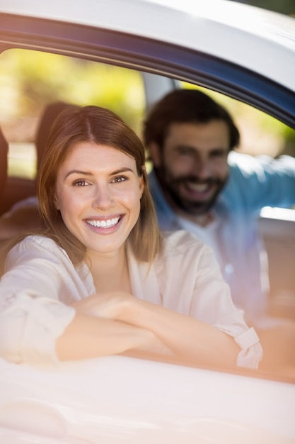 Happy couple sitting in a car