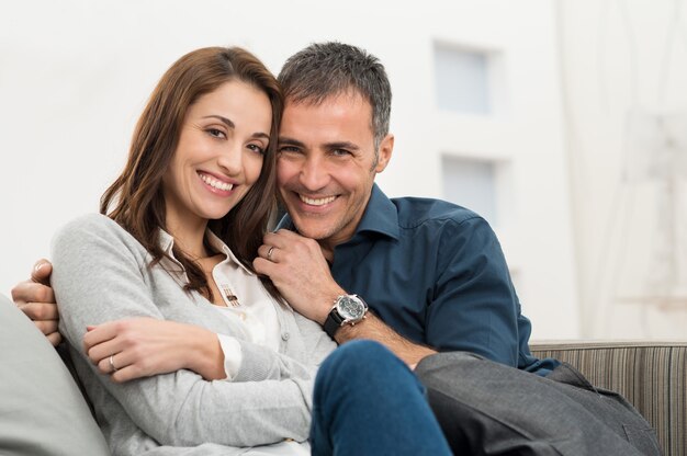 Happy Couple Sitting On Couch