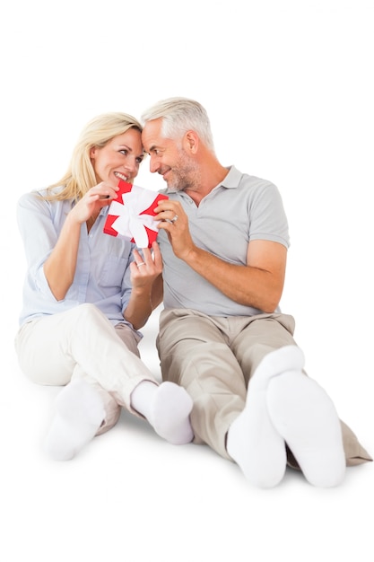 Happy couple sitting and holding present