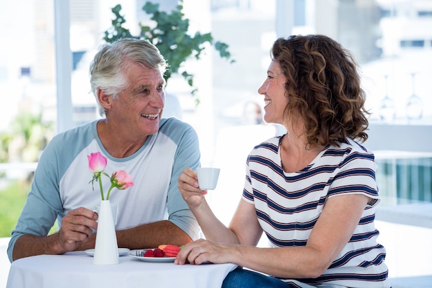 Happy couple sitting at restaurant