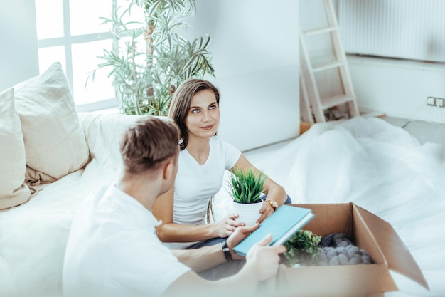 Happy couple sitting on the sofa in a new apartment