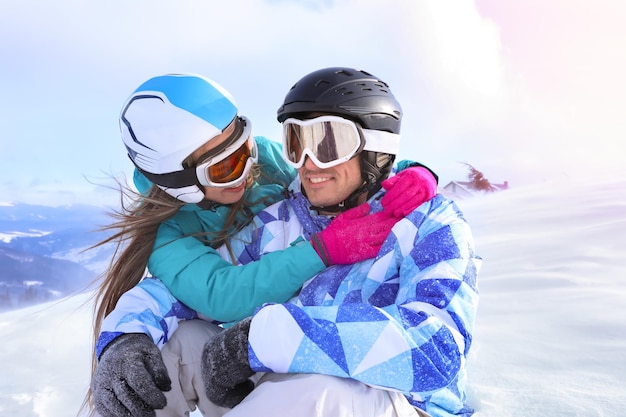 Happy couple at snowy ski resort Winter vacation