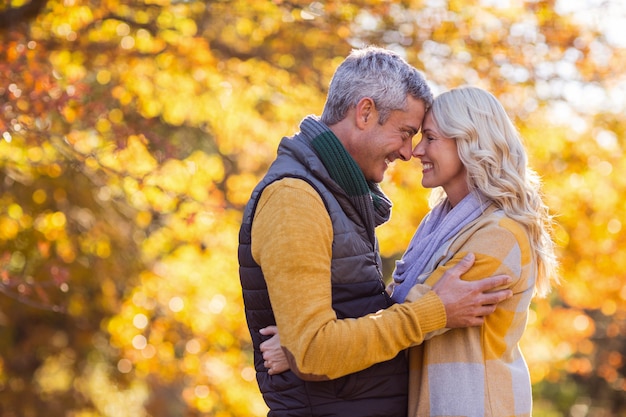 Happy couple standing face to face at park