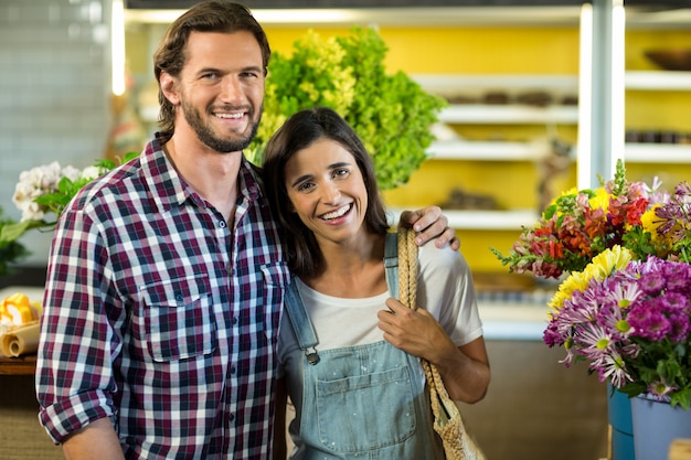 Happy couple standing in the florist shop