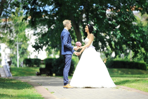 Happy couple standing in the Park on the day of the wedding