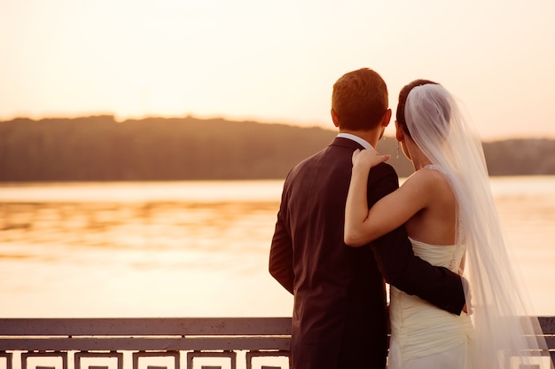 Happy couple standing on the pier