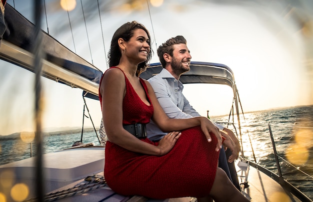 happy couple taking a romantic cruise on the sail boat