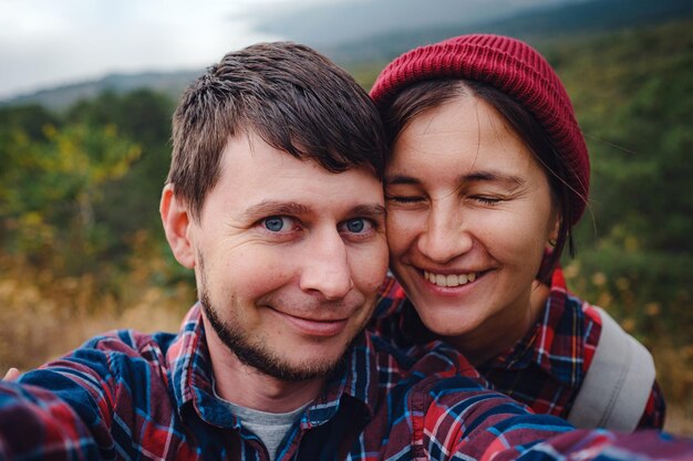 Happy couple taking selfie selfportrait photo hiking