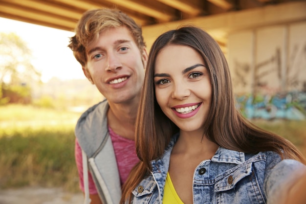 Photo happy couple taking selfie on street