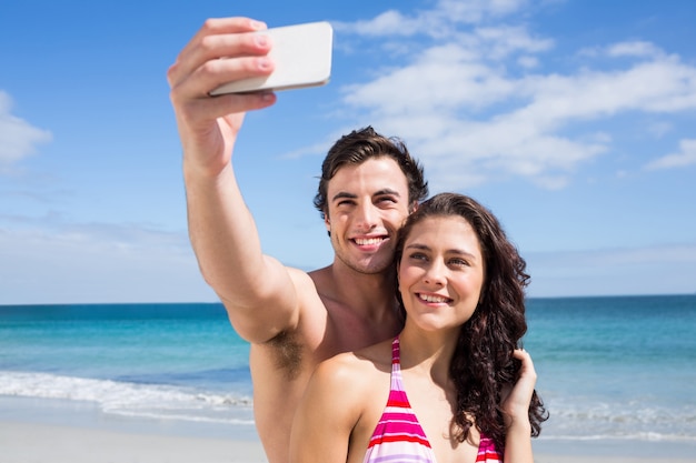 Happy couple taking selfie