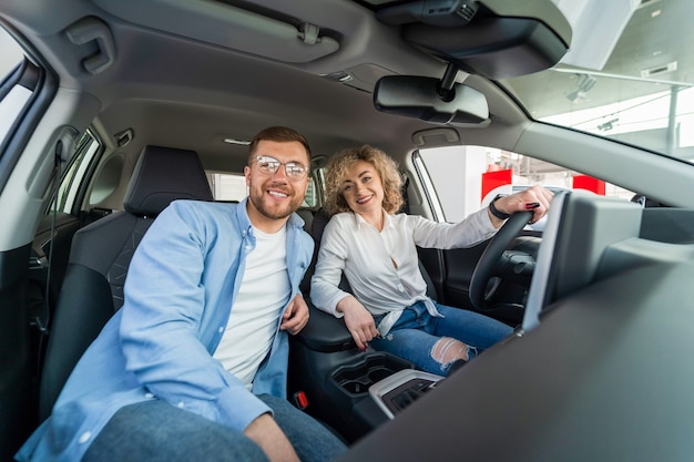 Happy couple in their new car