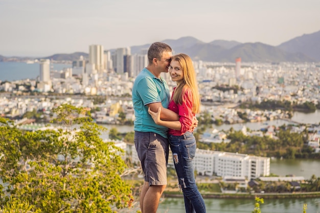 Happy couple tourists on the background of Nha Trang city Travel to Vietnam Concept