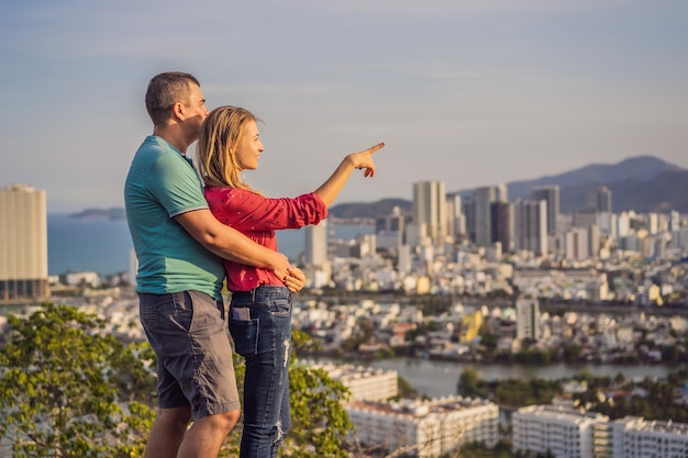 Happy couple tourists on the background of Nha Trang city Travel to Vietnam Concept