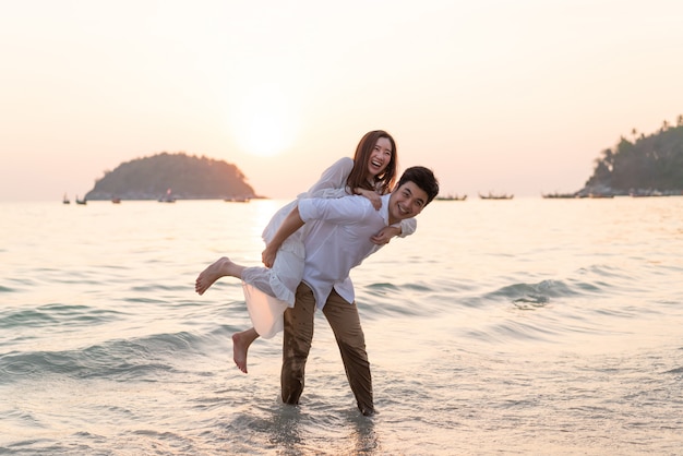 Happy couple on tropical beach in summer