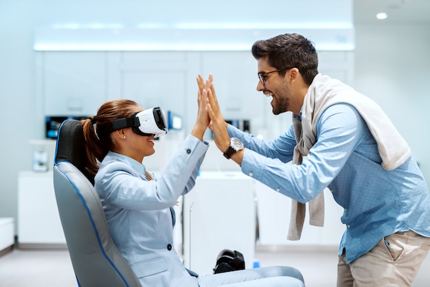 Happy couple trying out virtual reality technology