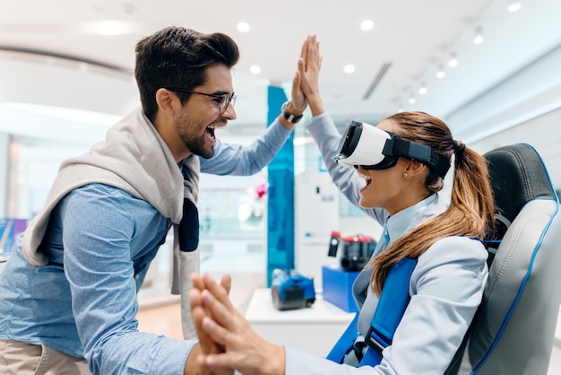 Happy couple trying out virtual reality technology