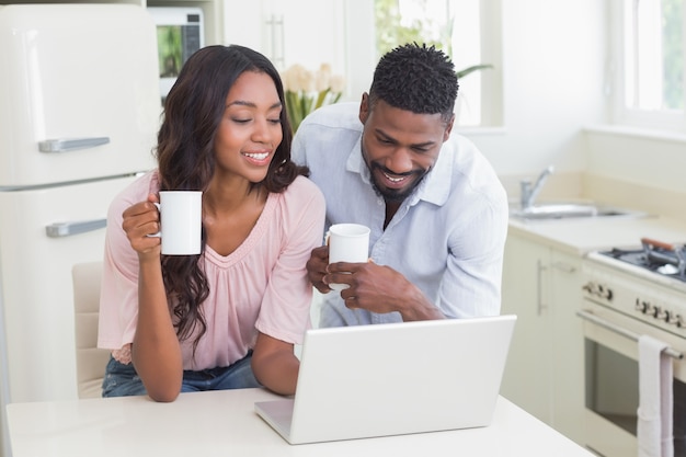 Happy couple using laptop together