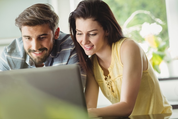 Happy couple using laptop