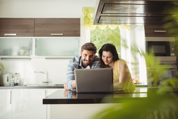 Happy couple using laptop