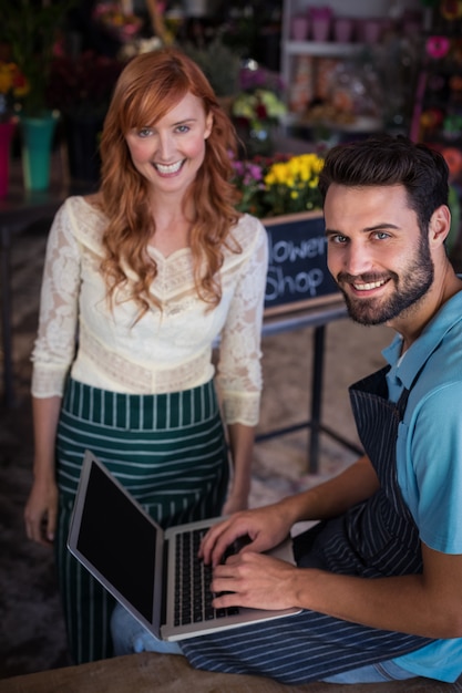 Happy couple using laptop