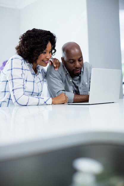 Happy couple using laptop