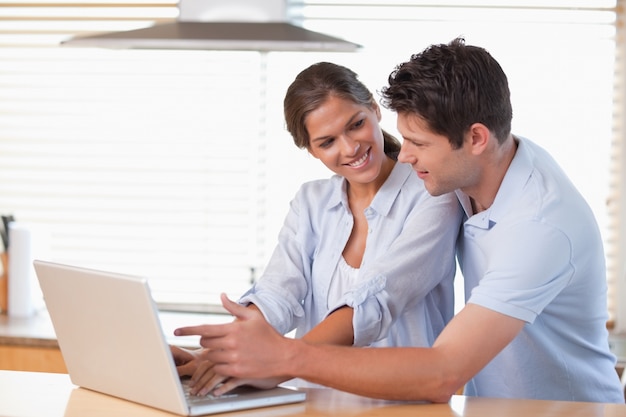 Happy couple using a laptop