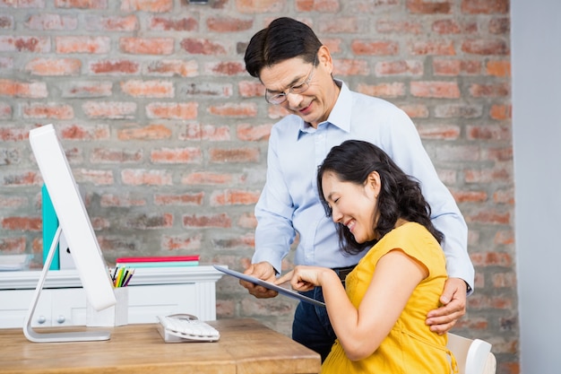 Happy couple using tablet at home