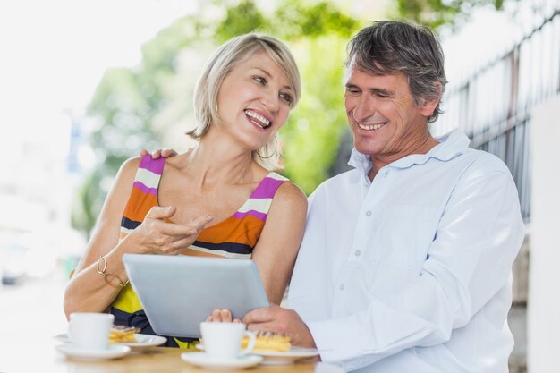 Happy couple using tablet