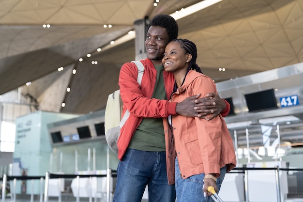 Happy couple waits plane in airport