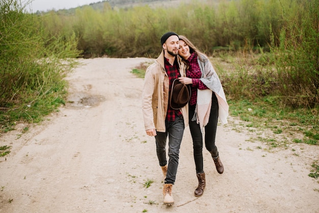 Happy couple walking on the nature at the mountains