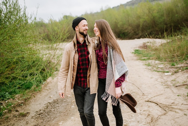 Happy couple walking on the nature at the mountains