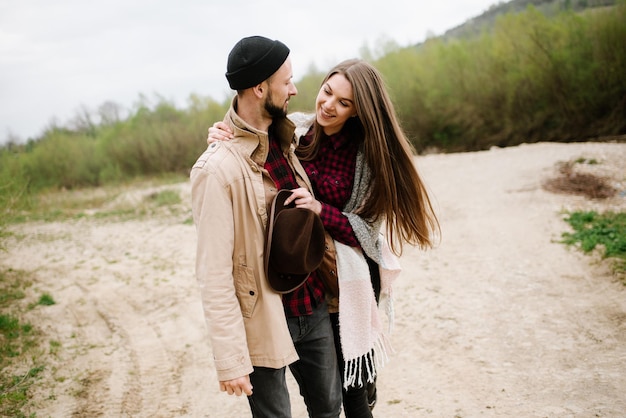 Happy couple walking on the nature at the mountains