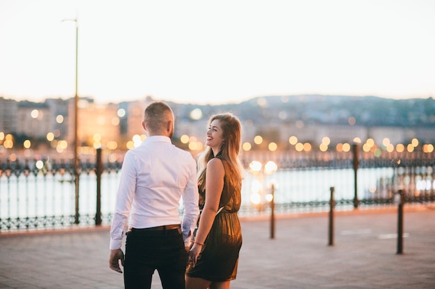 Happy couple walking in night city